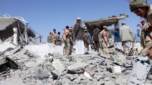 Soldiers and Houthi fighters isnpect damage caused by air strikes on the airport of Yemen's northwestern city of Saada, a Houthi stronghold near the Saudi border