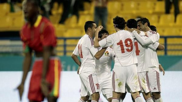 Jordan players celebrate after scoring their first goal against Palestine during their Arab Games soccer match in Doha